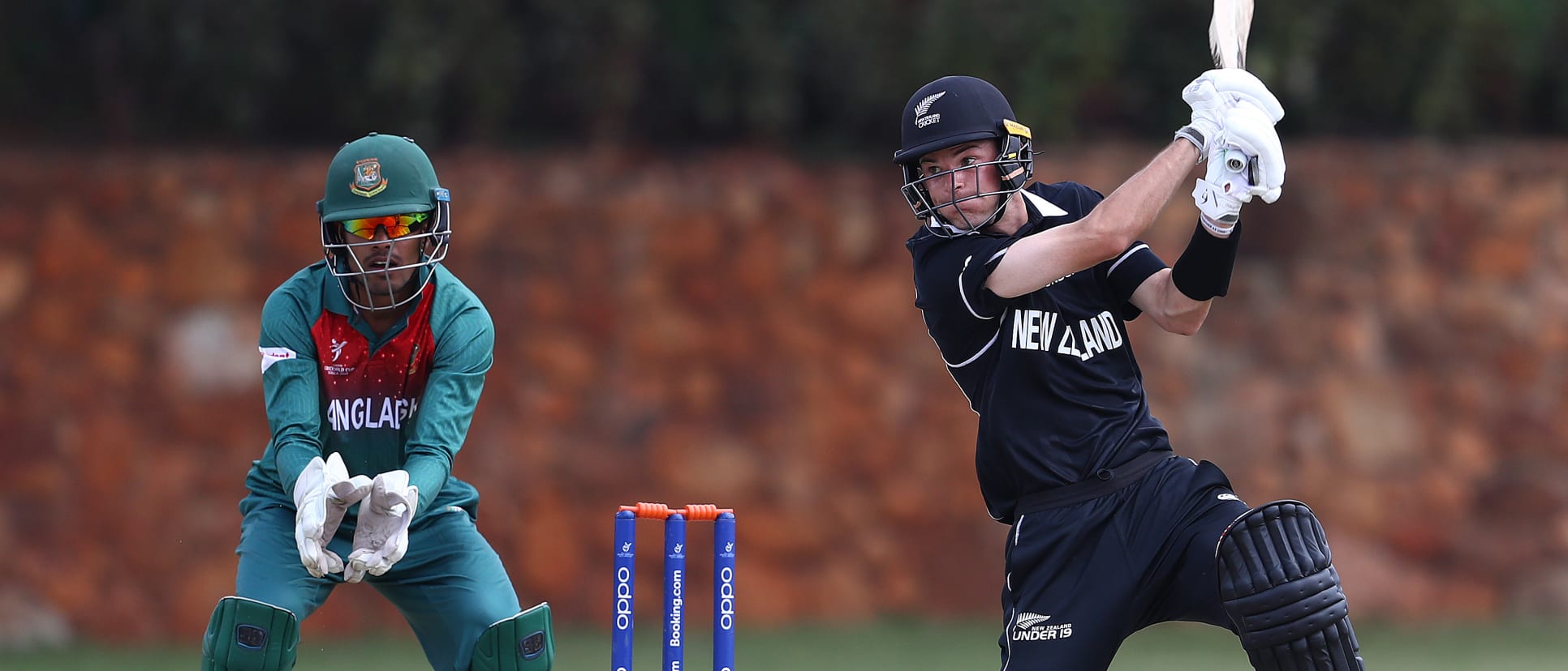 Jesse Tashkoff of New Zealand hits the ball towards the boundary, as Mohammad Akbar Ali of Bangladesh looks on during the ICC U19 Cricket World Cup warm up match between New Zealand and Bangladesh at St John's College on January 15, 2020.