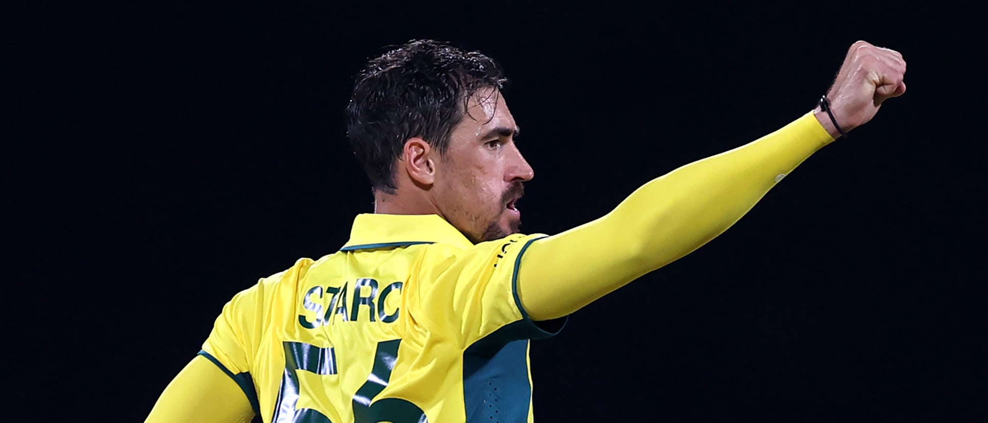 Mitchell Starc of Australia celebrates the wicket of Ishan Kishan of India during the ICC Men's Cricket World Cup India 2023