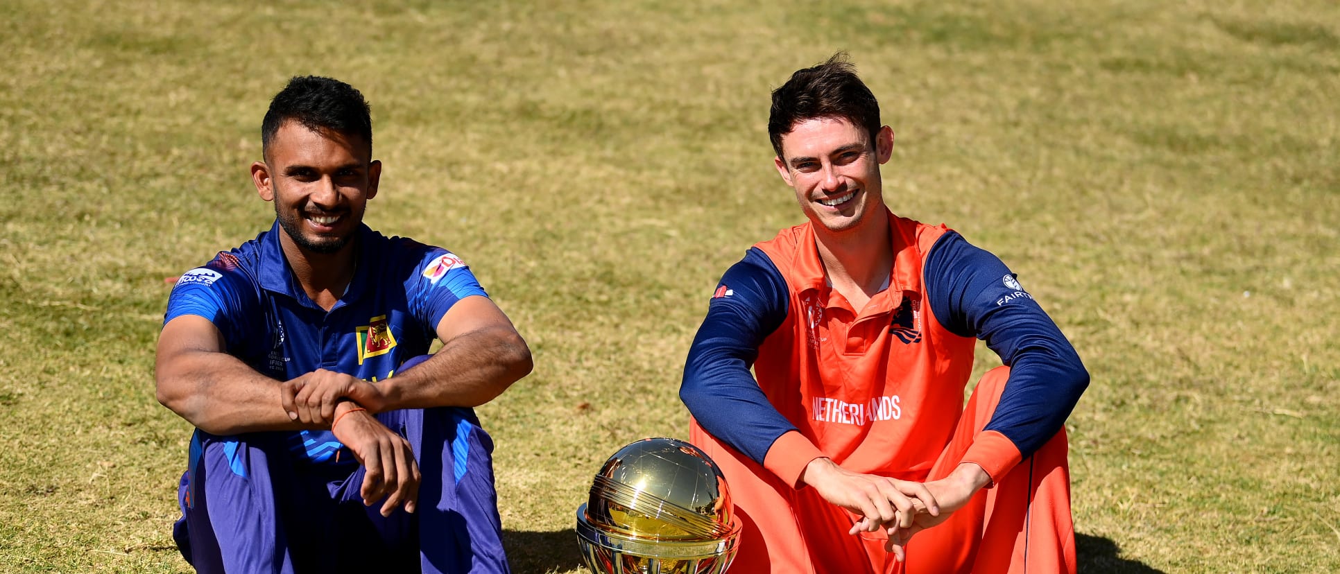 Dasun Shanaka of Sri Lanka and Scott Edwards of Netherlands pose for a photo with the ICC Men's Cricket World Cup Qualifier Trophy at Harare Sports Club on July 08, 2023 in Harare, Zimbabwe.