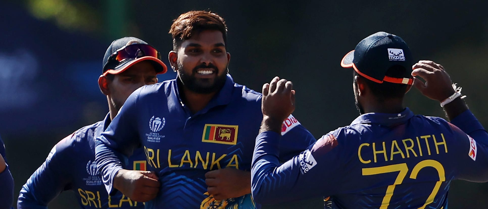 Wanindu Hasaranga of Sri Lanka celebrates with teammates after taking the wicket of Shoaib Khan of Oman during the ICC Men Cricket World Cup Qualifier Zimbabwe