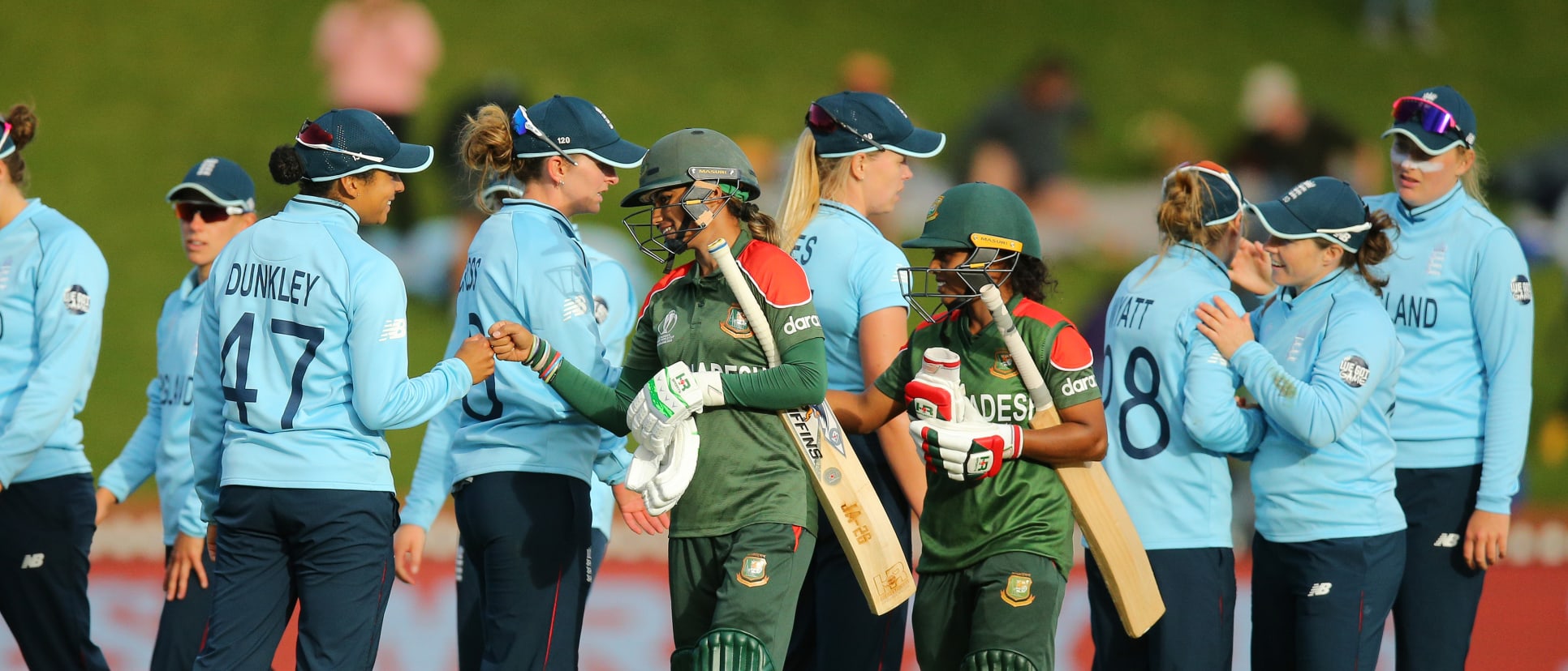 Players congratulate each other after the 2022 ICC Women's Cricket World Cup match between England and Bangladesh at Basin Reserve on March 27, 2022 in Wellington, New Zealand.