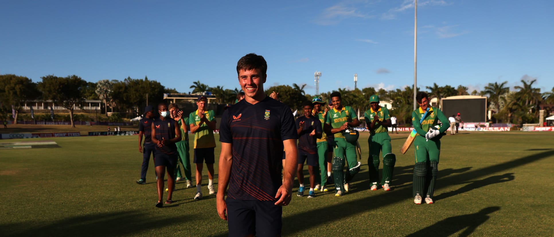 Brevis leads South Africa from the field following a victory