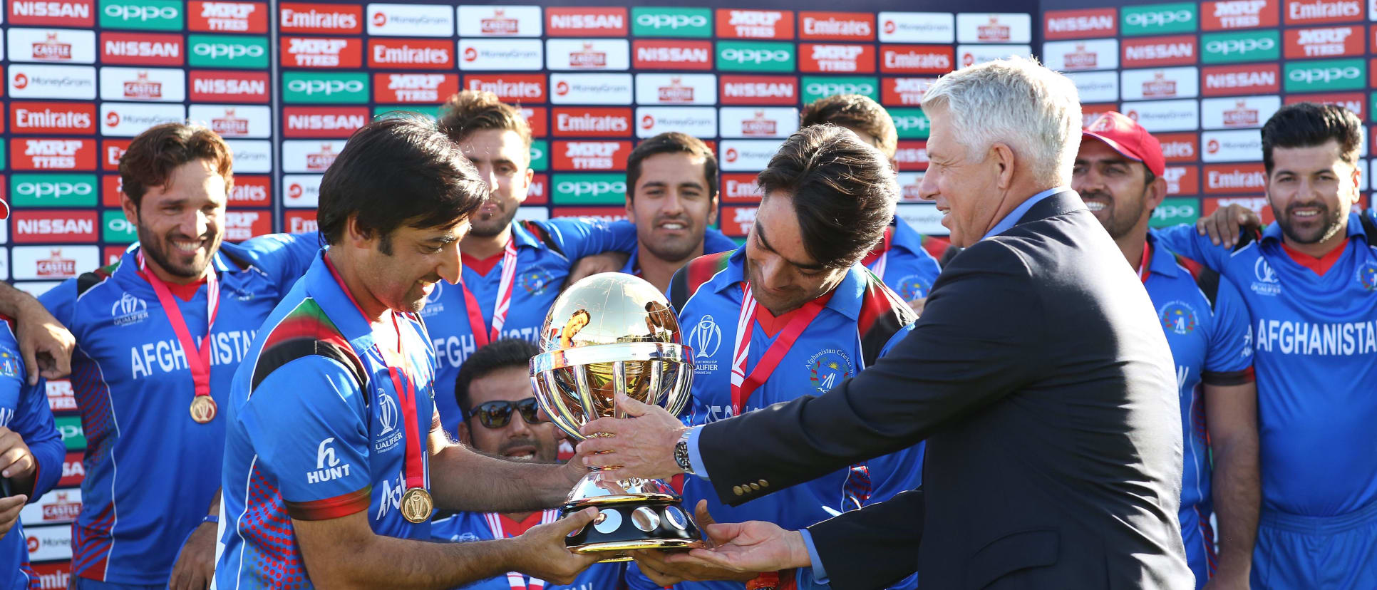 Dave Richardson of The ICC hands over the trophy to the wining Afghanistan team after The ICC Cricket World Cup Qualifier Final between The Windies and Afghanistan at The Harare Sports Club on March 25, 2018 in Harare, Zimbabwe (©ICC).