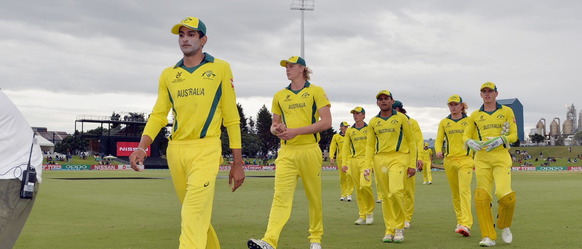 Jason Sangha and Australia's players leave the field