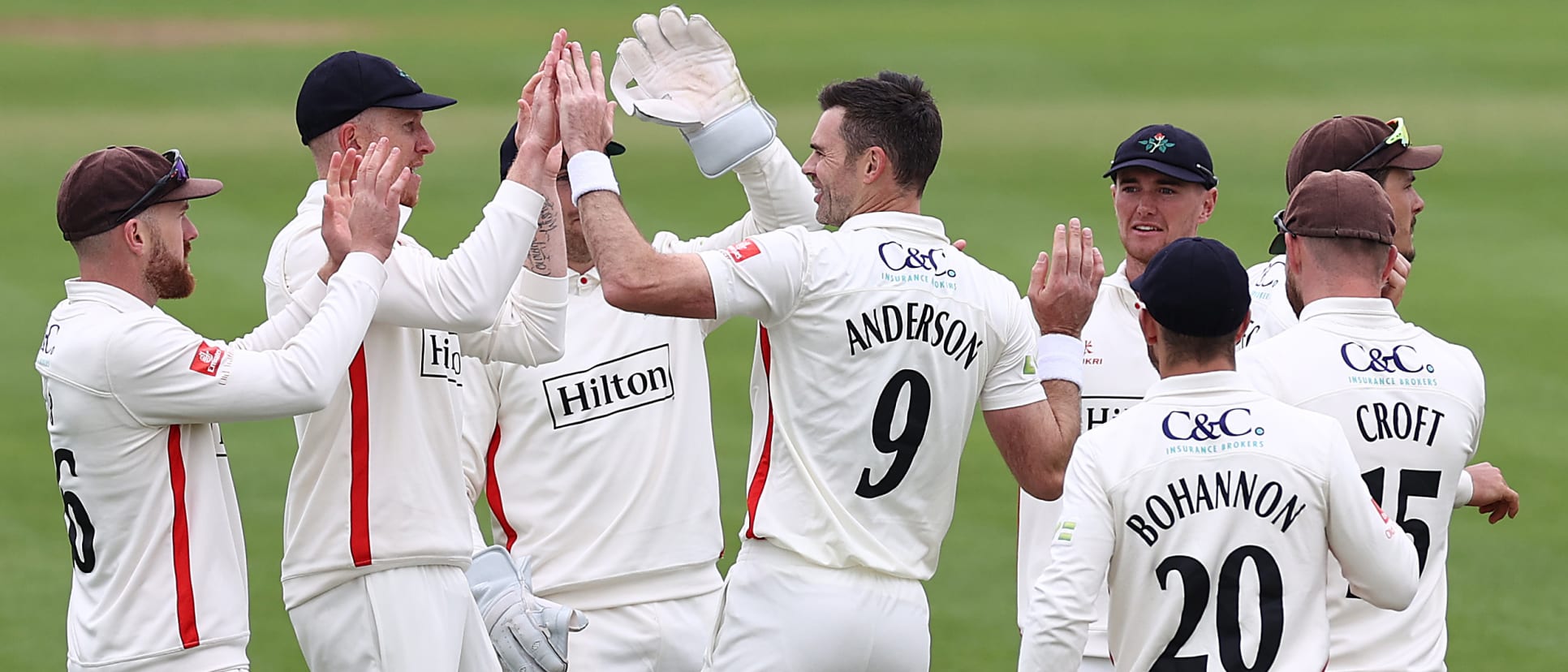 Anderson celebrates a wicket with his Lancashire teammates