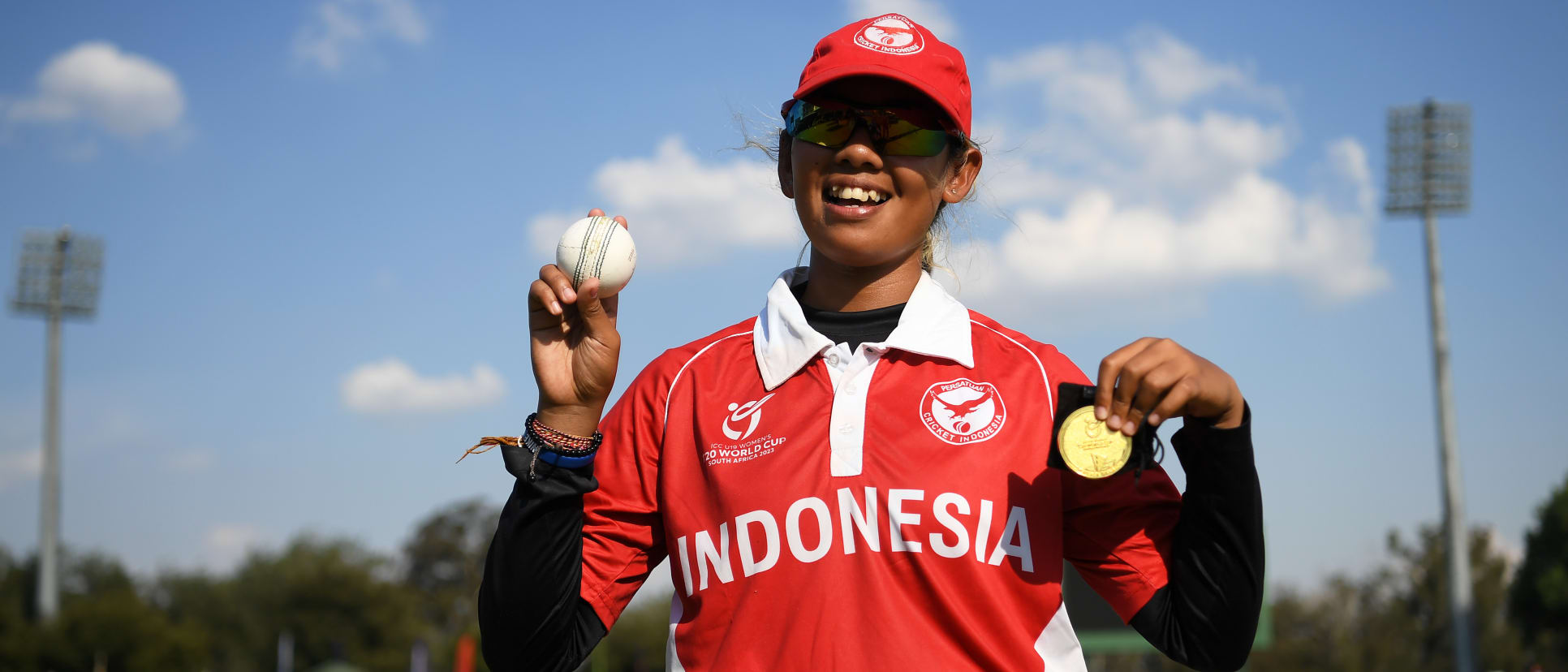 Ni Luh Ketut Dewi of Indonesia poses with the Player of the Match award and the match ball after taking five wickets following the ICC Women's U19 T20 World Cup 2023 4th place playoff match between Zimbabwe and USA at Willowmoore Park on January 20, 2023.