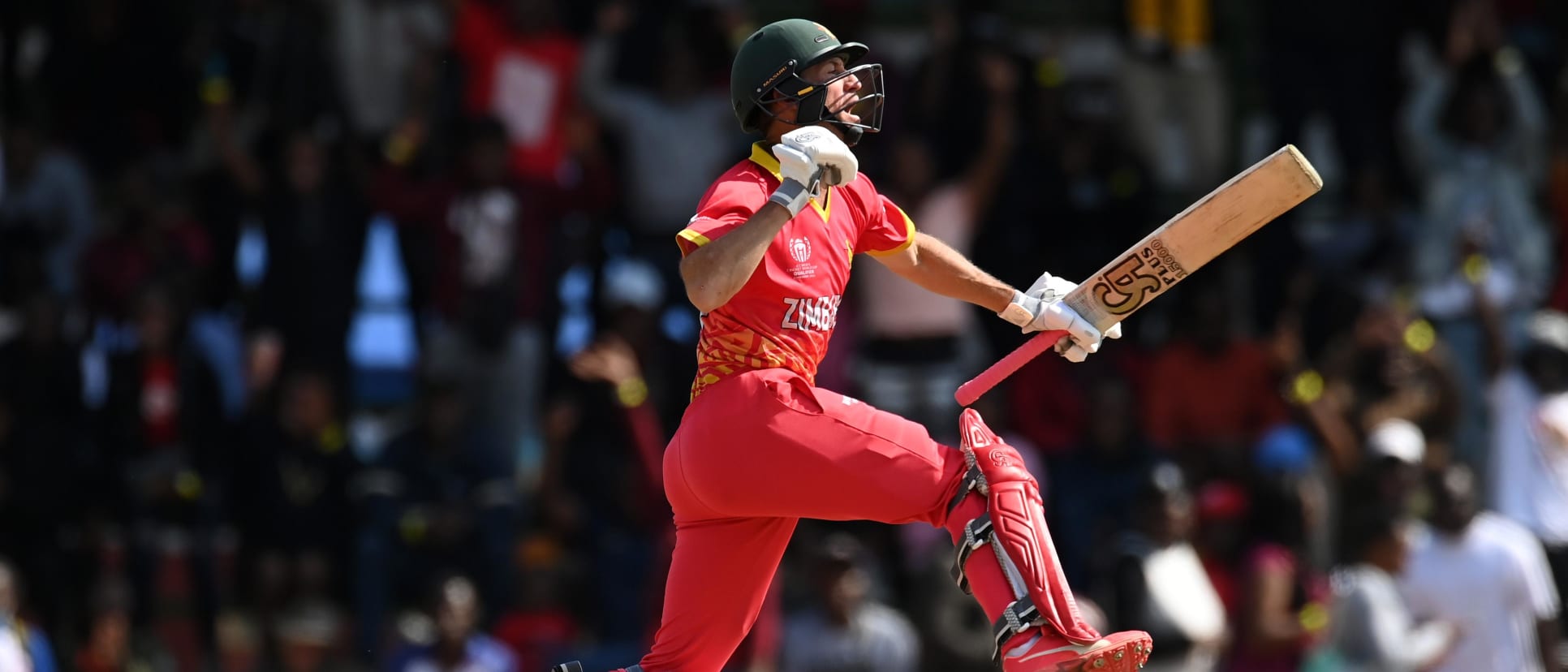 Sean Williams of Zimbabwe celebrates their century during the ICC Men's Cricket World Cup Qualifier Zimbabwe 2023 Super 6 match between Zimbabwe and Oman at Queen’s Sports Club on June 29, 2023 in Bulawayo, Zimbabwe.