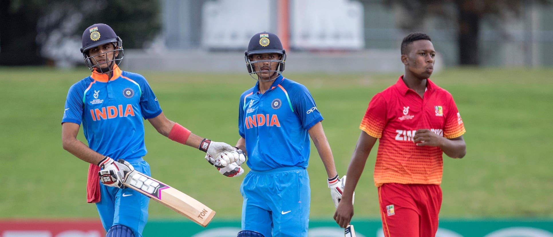 Shubman Gill (L) and Harvik Desai of India acknowledge an unbeaten partnership to win the match