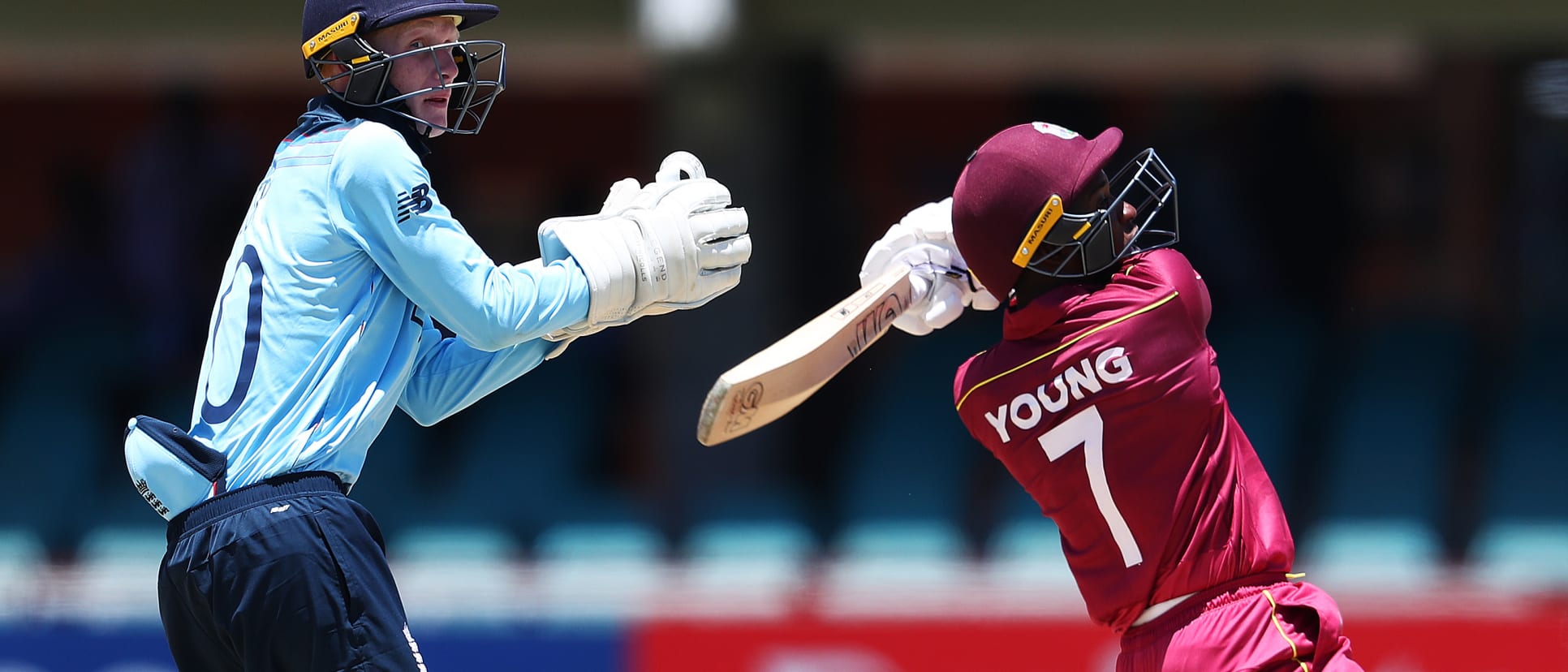 Nyeem Young of West Indies hits the ball towards the boundary, as Jordan Cox of England looks on during the ICC U19 Cricket World Cup Group B match between England and West Indies at De Beers Diamond Oval on January 20, 2020 in Kimberley, South Africa.