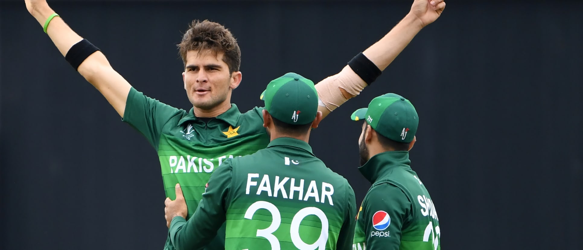 Pakistan's Shaheen Shah Afridi (L) celebrates with teammates Fakhar Zaman (C) and Shadab Khan