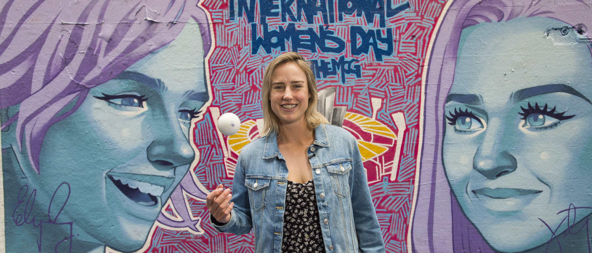 Ellyse Perry in front of finished mural