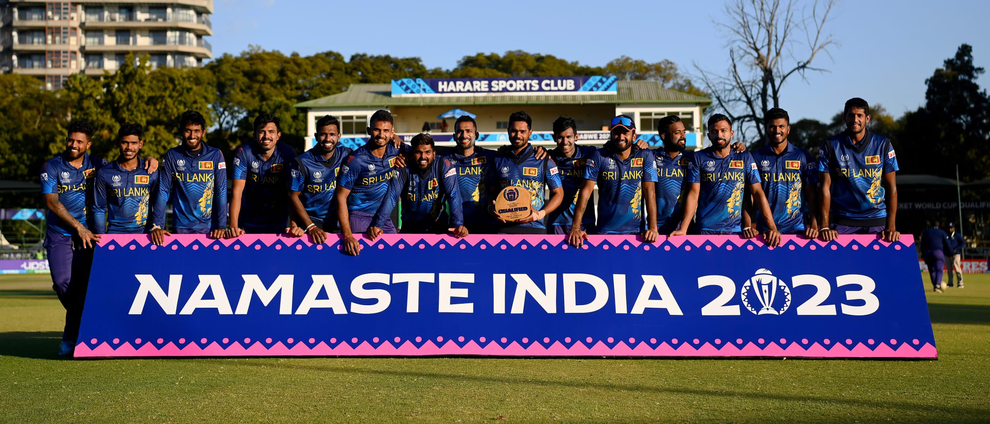 Dasun Shanaka lifts the trophy as players of Sri Lanka pose for a team photograph, as they celebrate after qualifiying for the ICC Men’s World Cup in India.