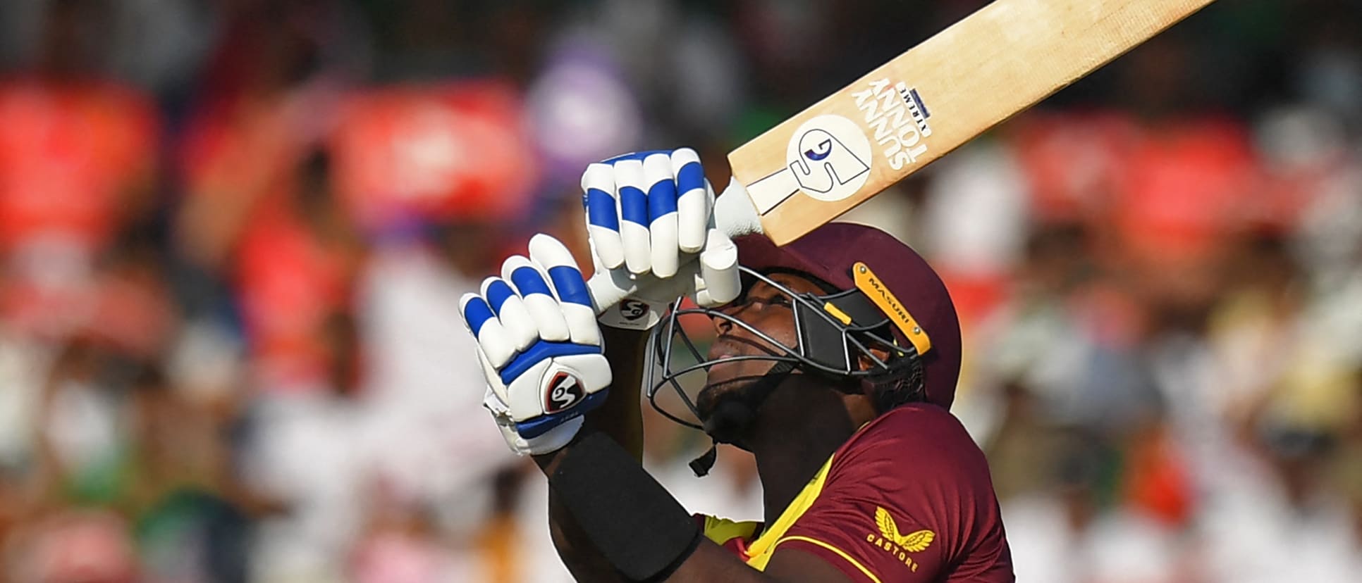 West Indies' Jason Holder hits a six during the ICC mens Twenty20 World Cup cricket match between Bangladesh and West Indies at the Sharjah Cricket Stadium in Sharjah on October 29, 2021.