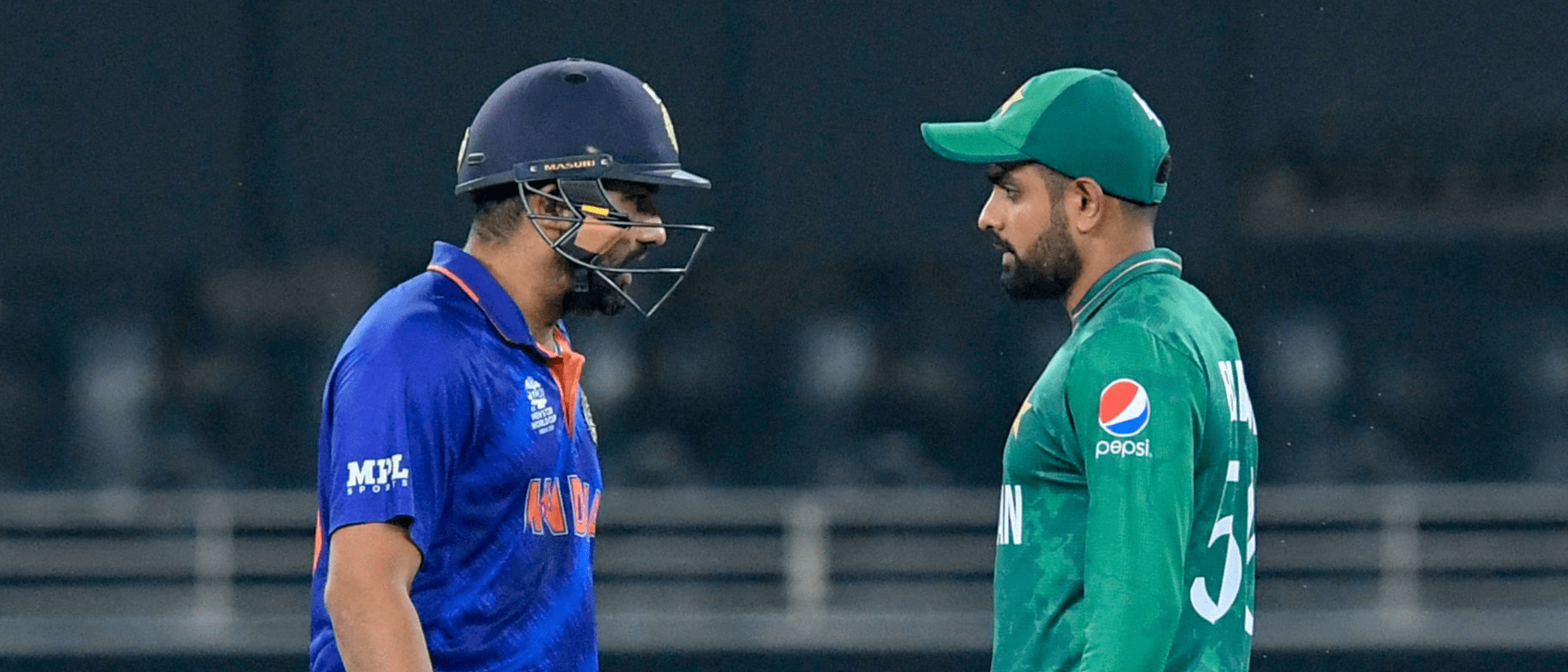 India's Rohit Sharma (L) walks past Pakistan's captain Babar Azam_1920x1080