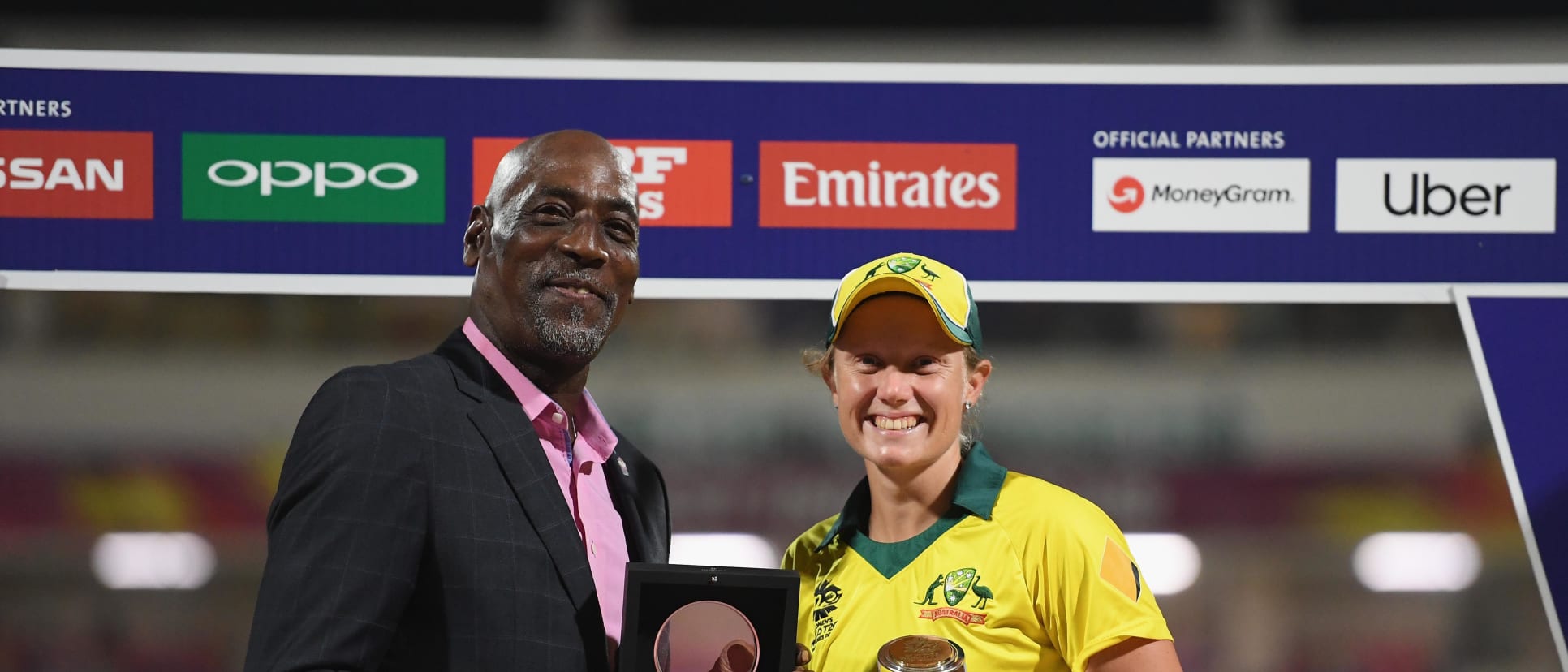 Alyssa Healy of Australia is presented with the Player of the Tournament award by Sir Viv Richards.
