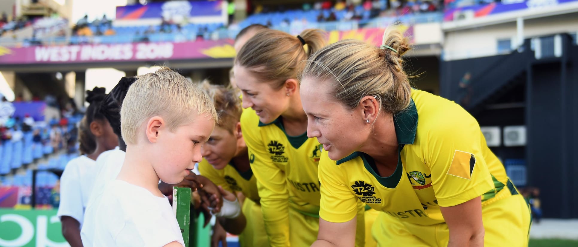 Meg Lanning of Australia shakes hands with a young mascot during the ICC Women's World T20 2018 Semi-Final match between Windies and Australia at Sir Viv Richards Cricket Ground on November 22, 2018 in Antigua, Antigua and Barbuda.