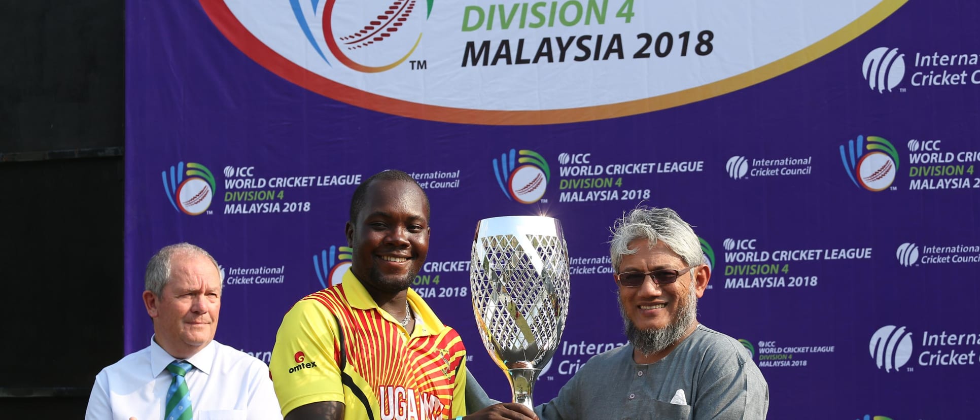 Uganda captain receives the WCL Div 4 champions trophy