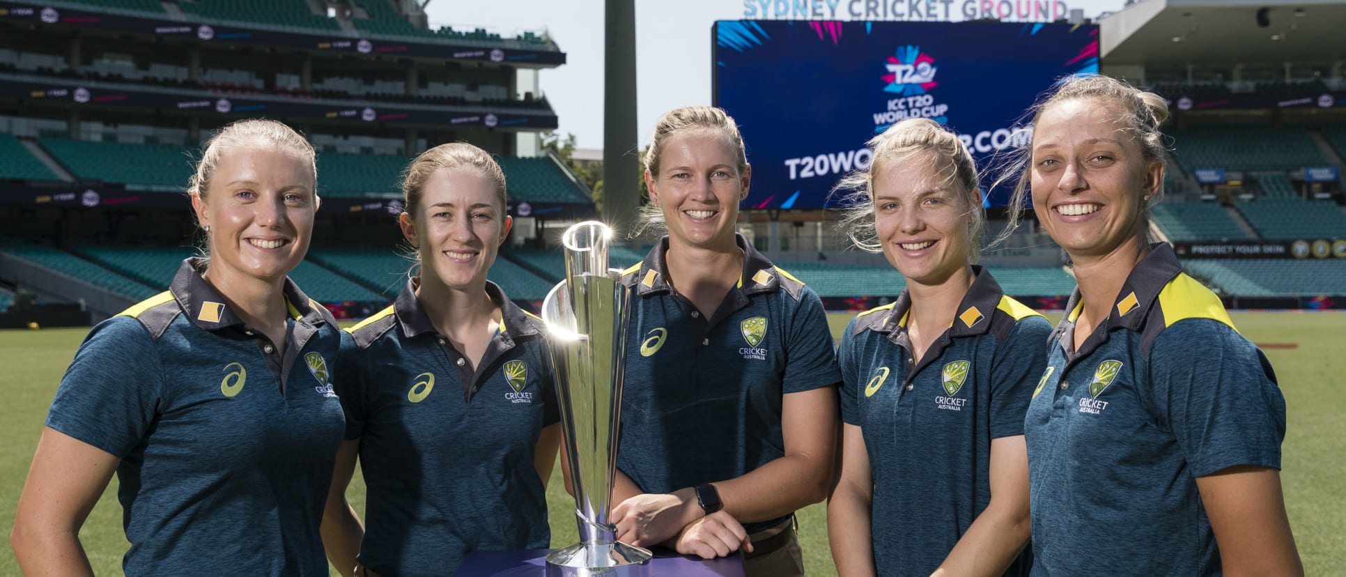 Members of the Australia Women's team pose with the ICC T20 World Cup 2020 trophy during the fixture announcement event