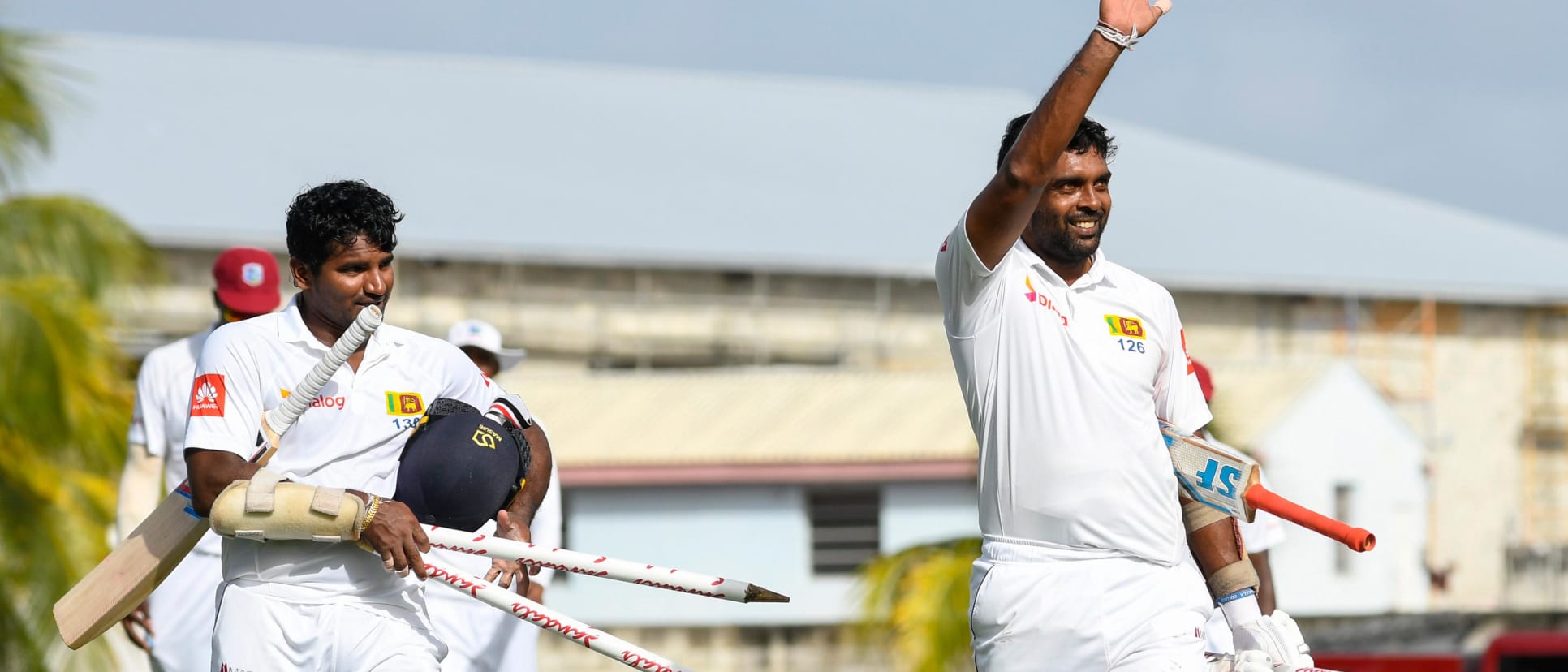 Dilruwan Perera and Kusal Perera celebrate victory