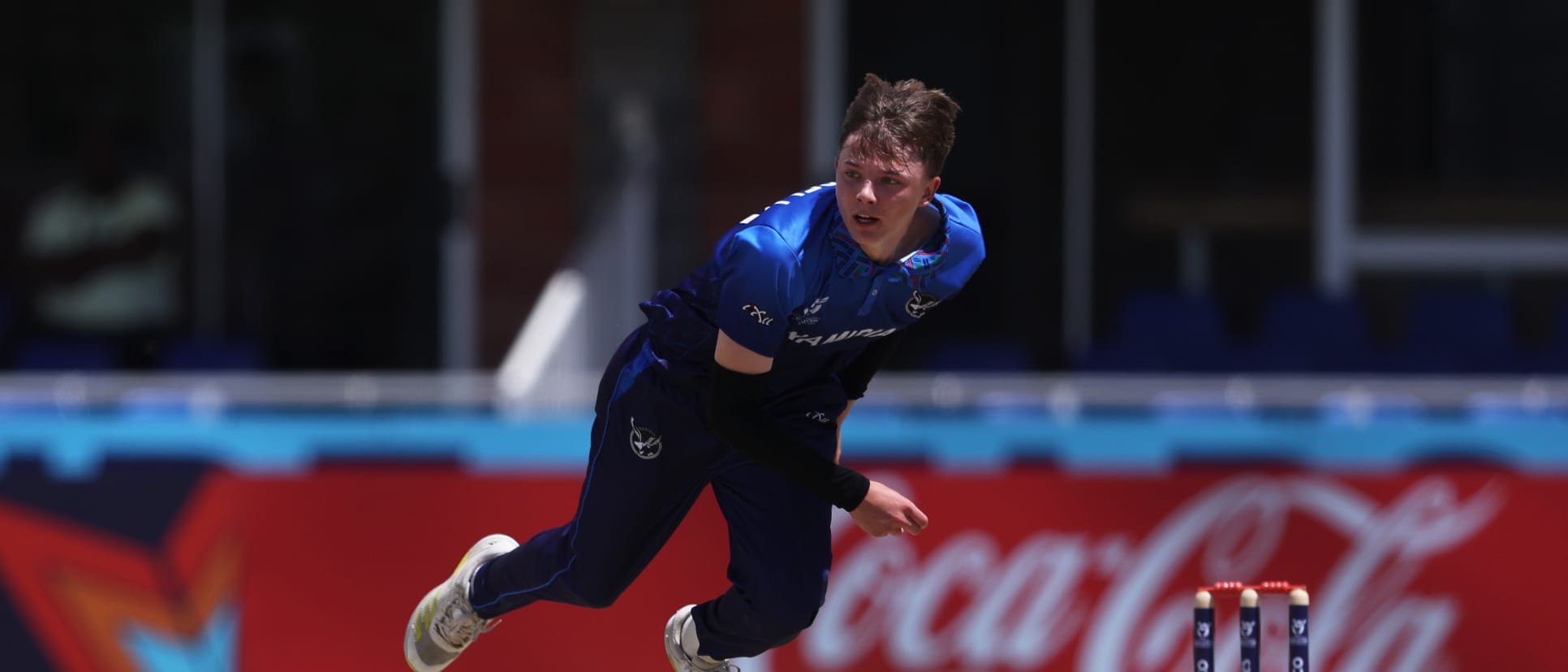 Jack Brassell of Namibia in bowling action during the ICC U19 Men's Cricket World Cup South Africa 2024 match between Australia and Namibia at Diamond Oval on January 22, 2024 in Kimberley, South Africa.