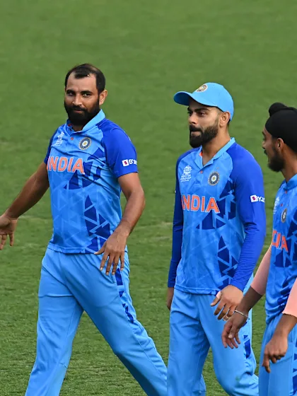 Logo of Virat Kohli with a diving direct hit to dismiss Tim David