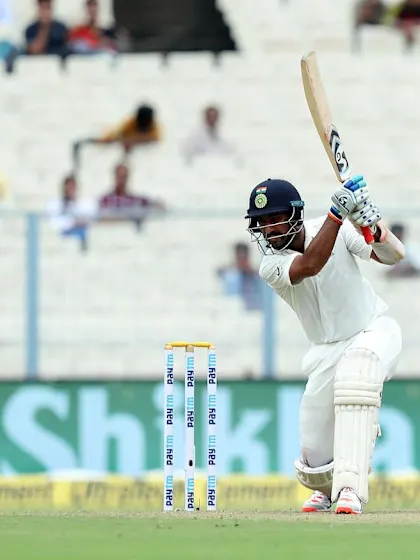 Pujara stands firm on rain-hit second day